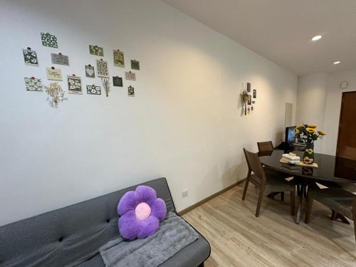 a living room with a couch with a purple flower on it at Joyful Seaview Studio 118 Island88 for 3pax in George Town