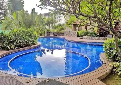 a swimming pool with blue water in a house at 1Br QC Furnished Condo FREE Pool Access, FAST WIFI in Manila