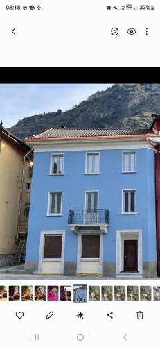 a picture of a blue building with a balcony at Ayurveda House in Biasca