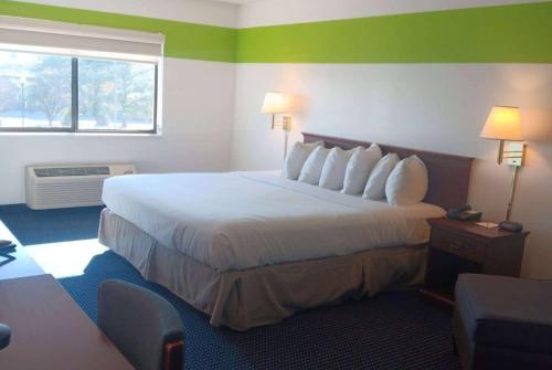 a hotel room with a large bed and a window at Ramada Limited - Mount Sterling in Mount Sterling