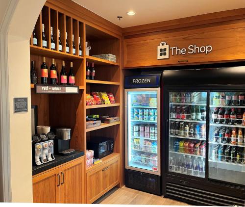 a store with a refrigerator and a shelf with drinks at Hilton Garden Inn Carlsbad Beach in Carlsbad