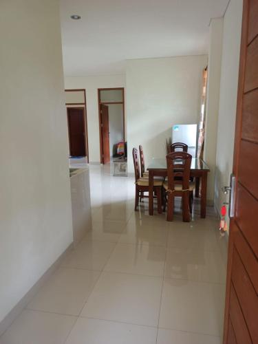 a kitchen and dining room with a table and chairs at villa beringin by andi tour in Sampal 2