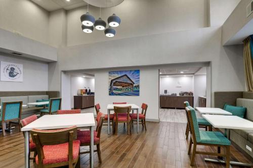 a dining room with white tables and chairs at Hampton Inn & Suites St. Louis - Edwardsville in Glen Carbon