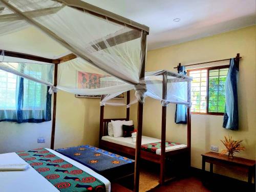 a bedroom with two bunk beds at Diana Place in Paje