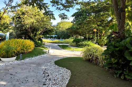 a walkway in a park with plants and trees at Dominiks pink dream Studio Balcony Ocean View Balcony Fast-Wifi at Tambuli Resort High Floor in Maribago