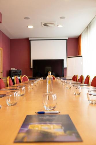 a conference room with a long table with wine glasses at Hotel Promenade in Montesilvano