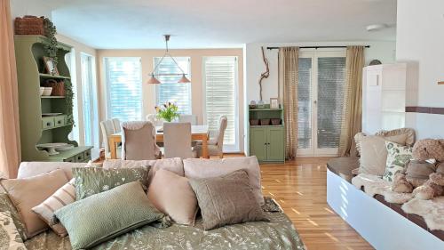 a living room with a couch and a dining room at HomeSlovenia - your Home in the Heart of Slovenia in Selca