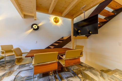 a dining room with a table and chairs and a staircase at Hotel-Restaurant Kostbar in Engen