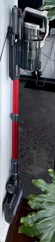 a red hose attached to a wall next to a plant at 44th Floor, Panoramic Views, Bay Corridor Downtown Toronto Condo in Toronto