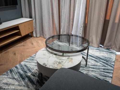 a coffee table with a glass top in a living room at On Park 516 At Century City in Cape Town