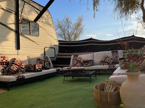 a group of couches sitting outside of a trailer at Rehla Rv Camper Van in Al Ain