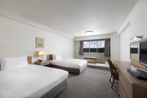 Postel nebo postele na pokoji v ubytování Mercure Fukuoka Munakata Resort & Spa