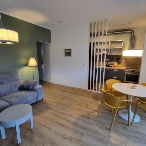 a living room with a couch and a table and chairs at Kastani Home 15 in Tartu