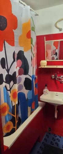 a bathroom with a flower shower curtain and a sink at Residence Paula in Jadranovo