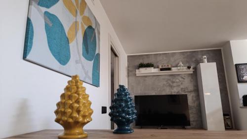 a living room with two vases and a fireplace at Silvia's at 141 in Genzano di Roma