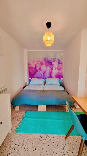 a bedroom with a bed with a painting on the wall at Soča Home Bovec in Bovec