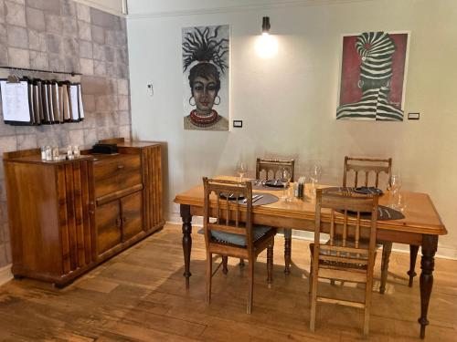 a dining room with a wooden table and chairs at Mimosa Lodge in Montagu