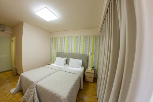 a bedroom with two beds and a window at Hotel Pitsakis in Tolo