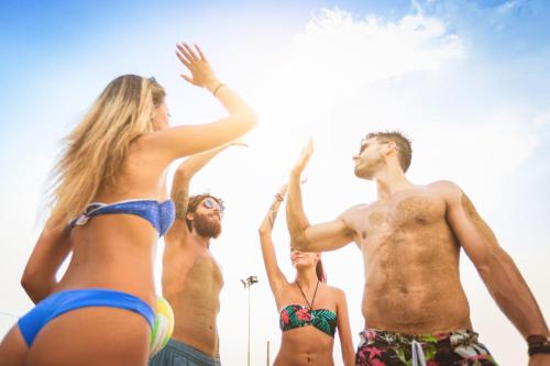 a group of people standing on the beach at Residence Renaione in Punta Ala