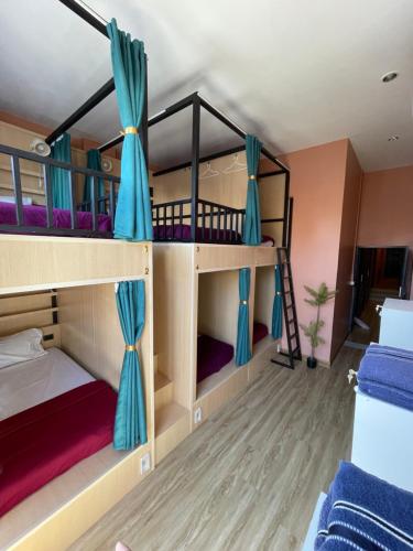 a room with bunk beds in a hostel at Plearn Phuket Boutique Hostel in Ban Lo Long