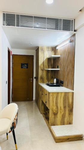 a kitchen with a counter and a wooden wall at Leisure Homes in Lucknow