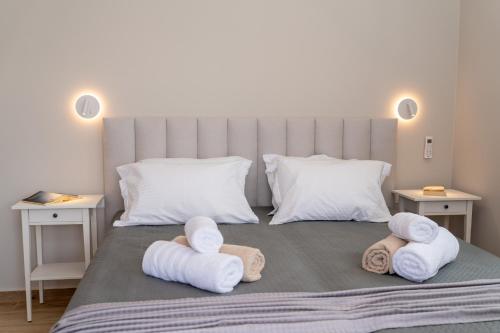 a bedroom with a bed with towels on it at Assos Rockshore Villa by the sea in Asos