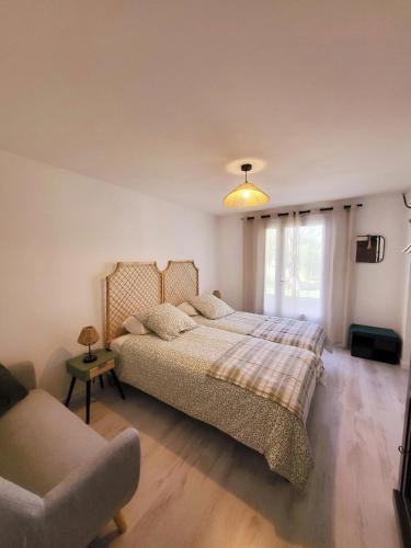 une chambre avec un grand lit et un canapé dans l'établissement La Villa aux Cyprès bleu, au Thor