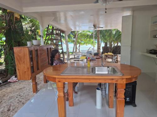 a kitchen with a wooden table with a sink at Remy's Eco house in Hernani
