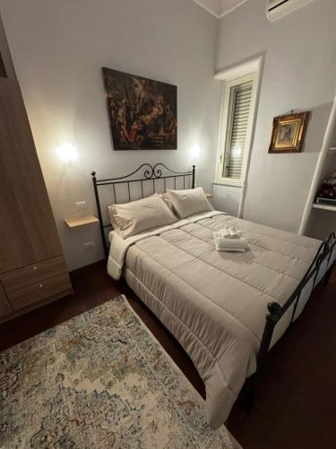 a bedroom with a large bed and a rug at Milion's house in Salerno