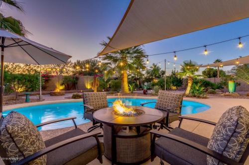 a patio with a table and chairs next to a pool at Blackfoot San Tan Valley in Queen Creek