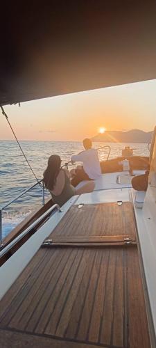 a group of people sitting on a boat watching the sunset at A Casa Di Gaia in Riccò del Golfo di Spezia