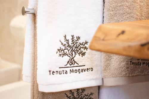a towel with the name of a tree on it at Tenuta Mogavero in Torre Canne