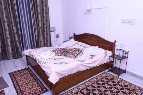a bedroom with a bed with a wooden frame at The Villa- a Home away from Home in Ajmer