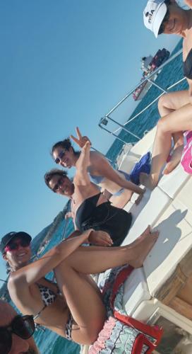 a group of women sitting on the side of a boat at A Casa Di Gaia in Riccò del Golfo di Spezia