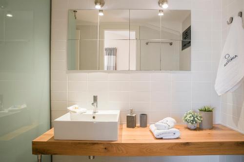 a bathroom with a sink and a mirror at Villa Astoria Exclusive luxury villa in Svoronata with breathtaking views and private grounds in Kefallonia