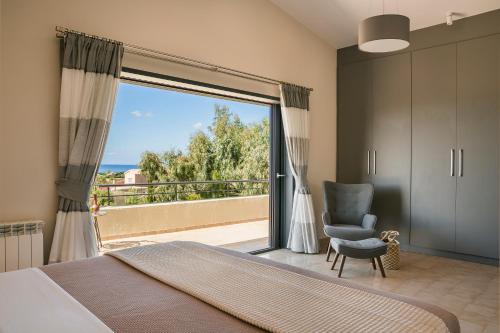 a bedroom with a bed and a sliding glass door at Villa Astoria Exclusive luxury villa in Svoronata with breathtaking views and private grounds in Kefallonia