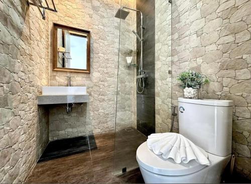 a bathroom with a toilet and a shower and a sink at The Blue Lion Villa Samui in Chaweng Noi Beach