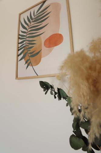 a teddy bear sitting next to a picture on a wall at Sublime Appartement avec Parking Privé à Ajaccio in Ajaccio