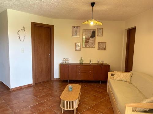 a living room with a couch and a table at Appartement, 60m2, 6 couchages avec piscines à Marine de Bravone, Linguizetta, résidence Sognu Di mare Corse in Linguizzetta