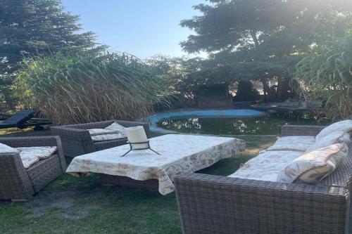 a backyard with a table and chairs and a pool at Comfortable holiday home with sauna and whirlpool in Lubin