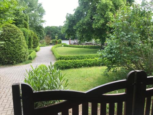 a bench sitting next to a garden with a pathway at Terassenblick am See in Grimma