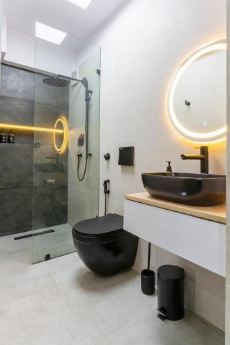 a bathroom with a black toilet and a sink at Premium 2BR Apartment in Kathmandu near Thamel 3 in Kathmandu