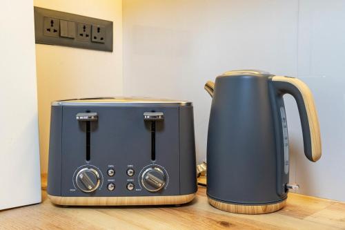 two toasters sitting next to each other on a counter at Premium 2BR Apartment in Kathmandu near Thamel 3 in Kathmandu