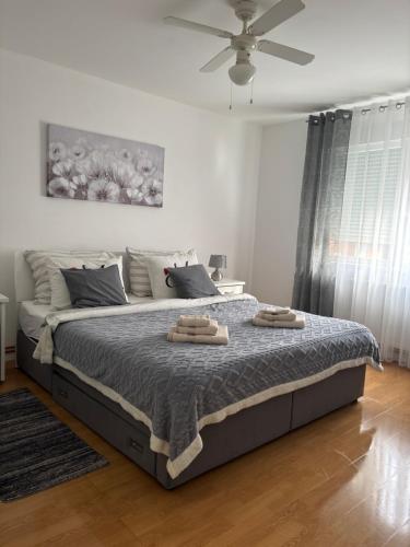 a bedroom with a bed with two towels on it at Apartman Slavica self check in,private parking in Osijek
