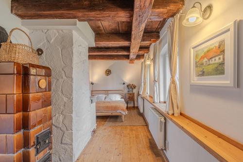 a hallway with a room with a bed and a wall at Palitz No 17 - venkovské stavení in Lipová