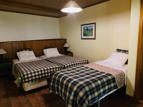 a hotel room with two beds in a room at Quinta da Memória Village in Vimieiro