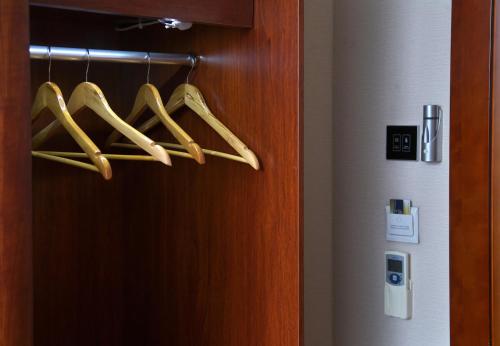 a rack of hangers with hangers next to a door at Grand Voyage Hotel in Almaty