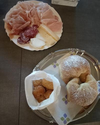 two plates with different types of food on a table at B&B LA VALLUNA in Erbusco