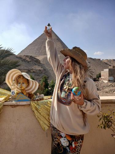 a woman standing in front of the pyramid at Crystal pyramid inn in Cairo