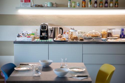 a table with plates of food on top of a counter at B&B LA VALLUNA in Erbusco